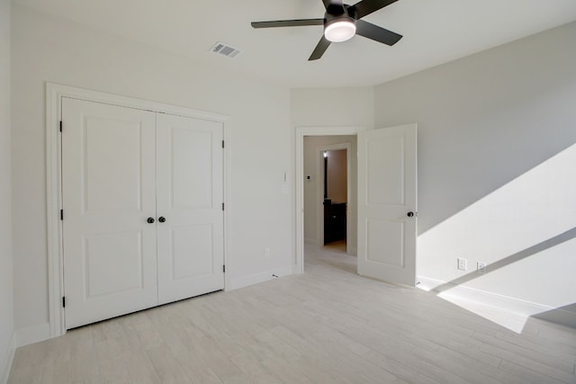 117 Callie St, Smithville, TX 78957 - unfurnished bedroom with light wood-type flooring, baseboards, a closet, and a ceiling fan