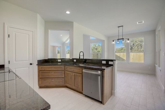 117 Callie St, Smithville, TX 78957 - kitchen featuring dishwasher, a sink, brown cabinetry, dark stone counters, and recessed lighting