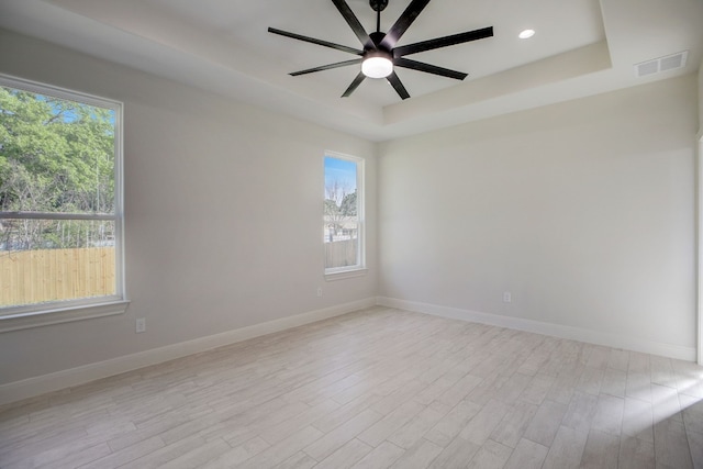 117 Callie St, Smithville, TX 78957 - unfurnished room featuring a raised ceiling, light wood-style floors, a ceiling fan, baseboards, and recessed lighting