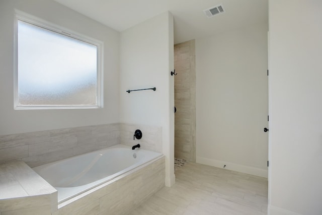 117 Callie St, Smithville, TX 78957 - bathroom featuring a bath and tiled shower