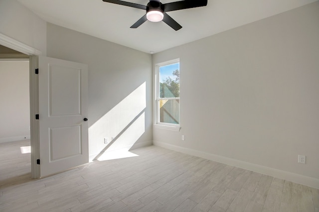 117 Callie St, Smithville, TX 78957 - spare room with a ceiling fan, light wood-style floors, and baseboards