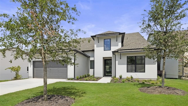 view of front of house featuring a front lawn and a garage