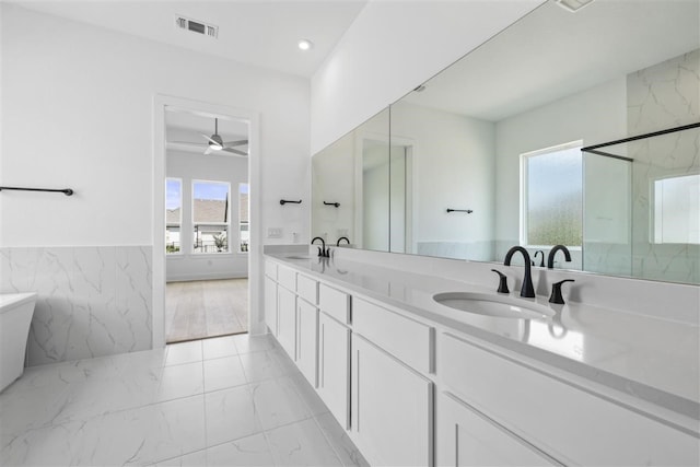 bathroom with vanity, a shower with door, ceiling fan, and plenty of natural light