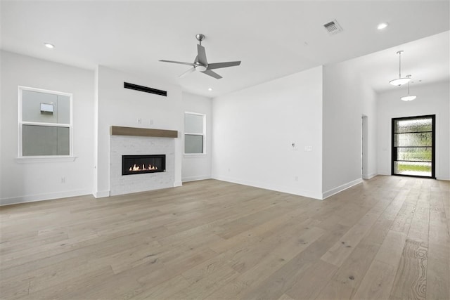 unfurnished living room featuring light hardwood / wood-style floors and ceiling fan