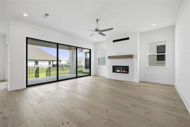 unfurnished living room with light wood-type flooring and ceiling fan