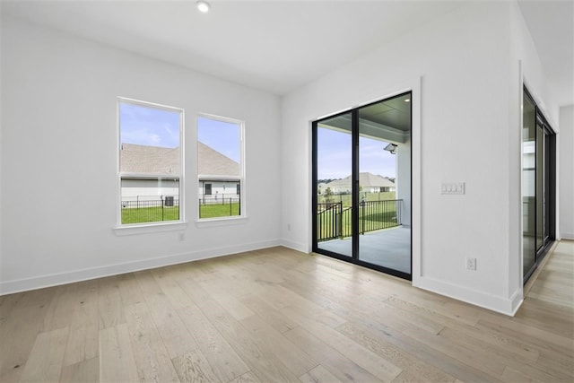 unfurnished room with light hardwood / wood-style floors