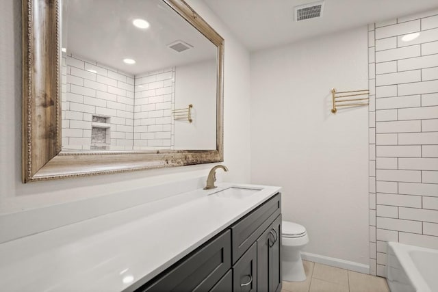 full bathroom featuring tile patterned floors, toilet, tiled shower / bath combo, and vanity