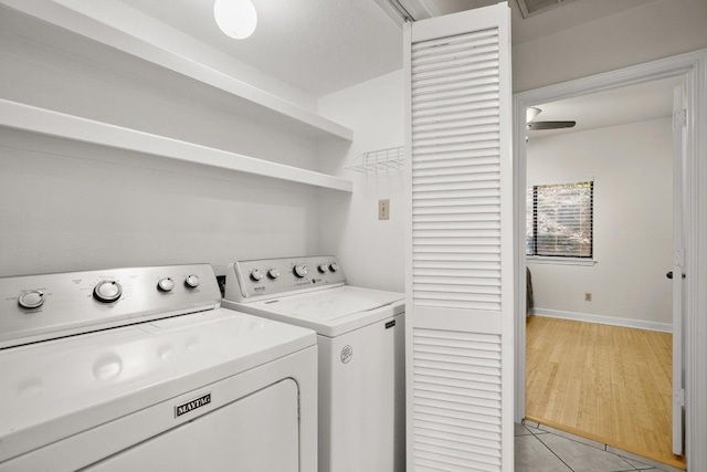 laundry area featuring separate washer and dryer and light tile patterned flooring