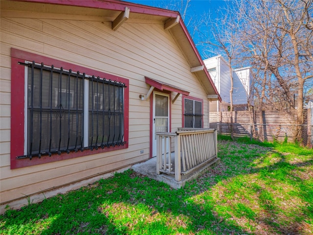 view of exterior entry featuring a yard