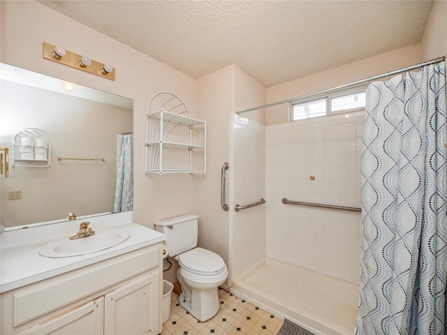 bathroom with tile flooring, toilet, vanity with extensive cabinet space, a textured ceiling, and walk in shower