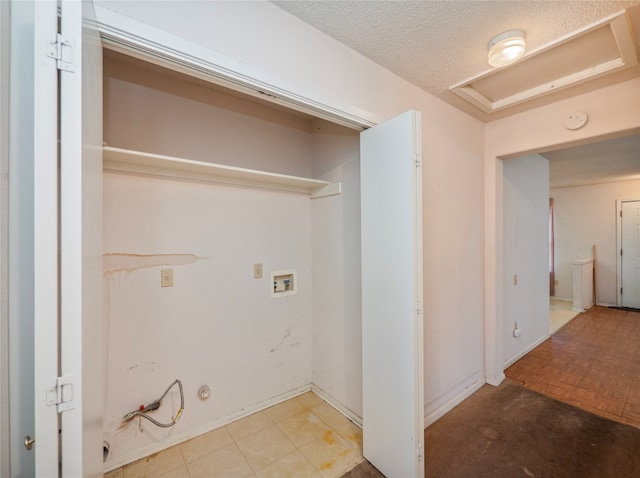 clothes washing area featuring hookup for a washing machine, a textured ceiling, and light parquet floors