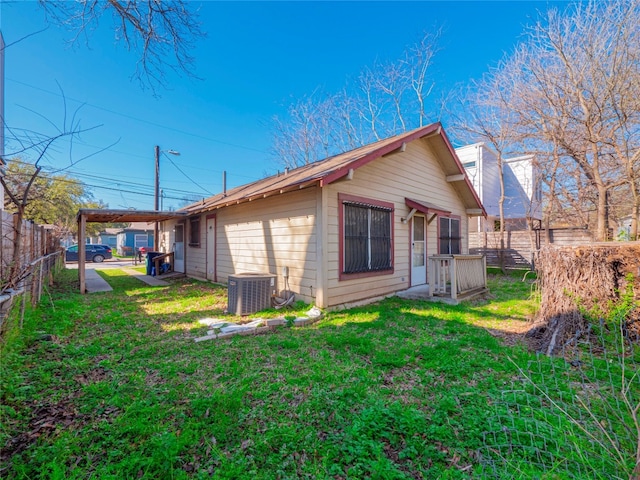 view of side of property featuring a lawn and central AC unit