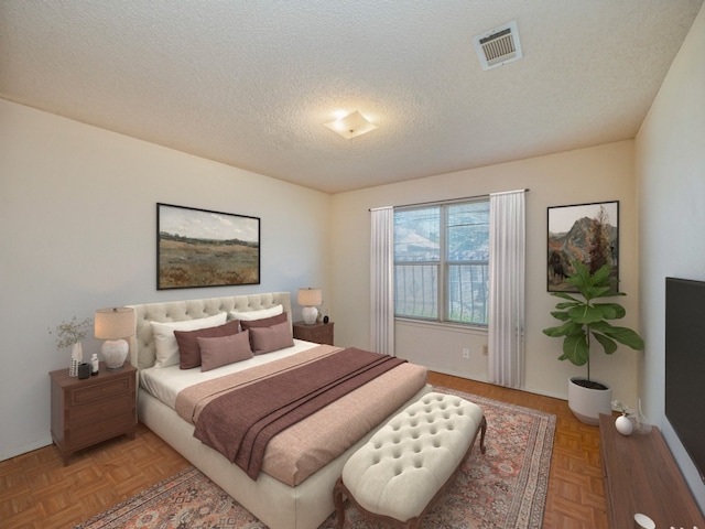 bedroom with light parquet flooring and a textured ceiling