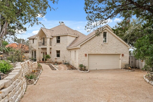 view of front of house featuring a balcony and a garage