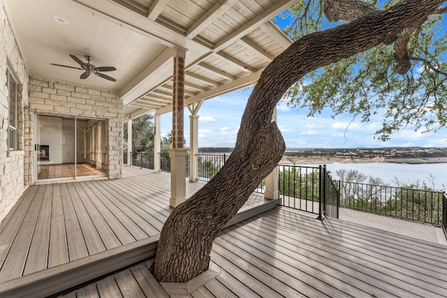 wooden terrace with ceiling fan and a water view