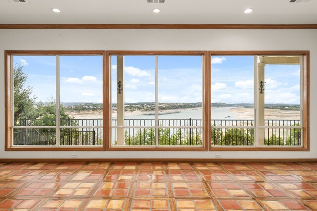 unfurnished sunroom with a water view