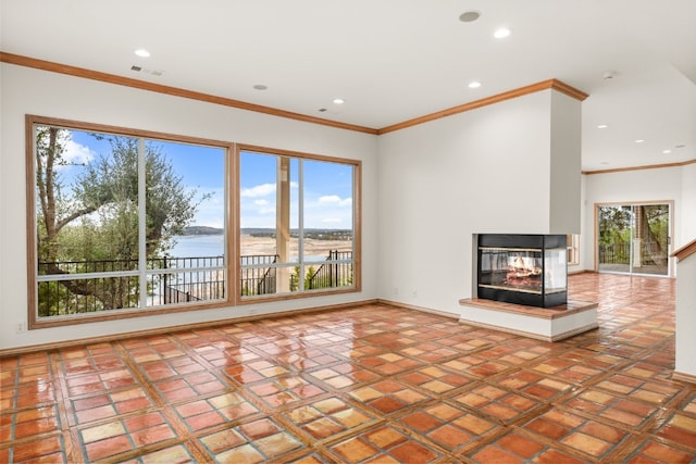 unfurnished living room with a multi sided fireplace, a water view, and crown molding