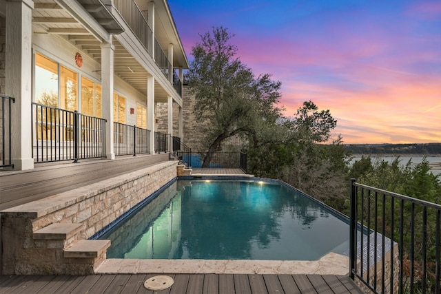 view of pool at dusk