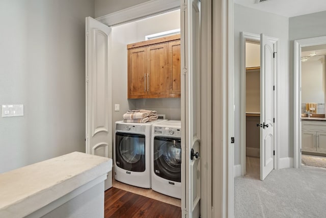 laundry area with cabinets, separate washer and dryer, and dark colored carpet