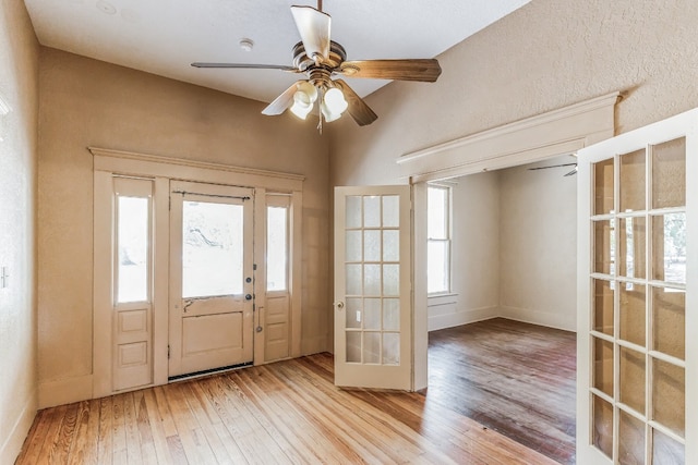 doorway featuring ceiling fan, light hardwood / wood-style floors, and french doors