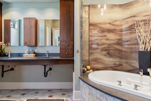 bathroom with tiled bath and sink