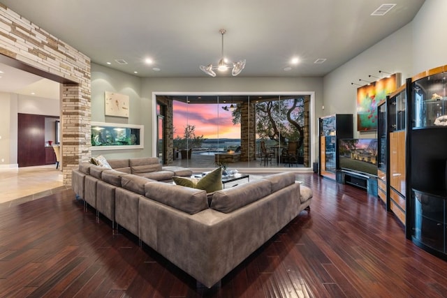 living room featuring dark hardwood / wood-style flooring and an inviting chandelier