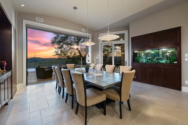 dining space featuring vaulted ceiling