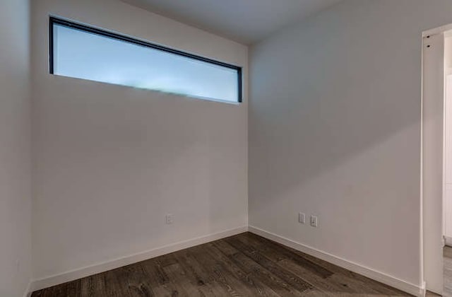 unfurnished room featuring dark wood-type flooring