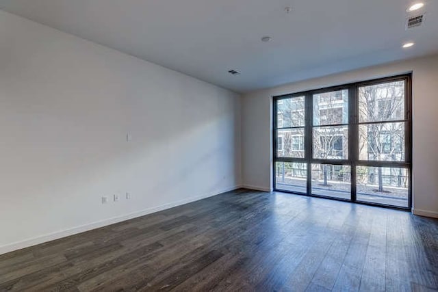 unfurnished room with dark hardwood / wood-style floors