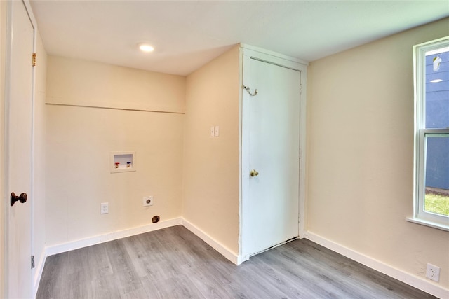 washroom with washer hookup, hookup for an electric dryer, and light hardwood / wood-style floors