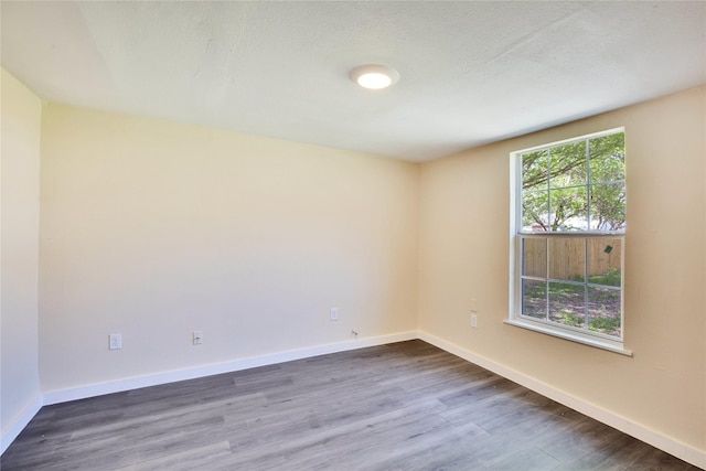 unfurnished room featuring dark wood-type flooring