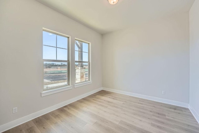 empty room featuring baseboards and light wood-style floors