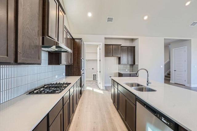kitchen featuring a sink, dishwasher, extractor fan, gas cooktop, and dark brown cabinetry