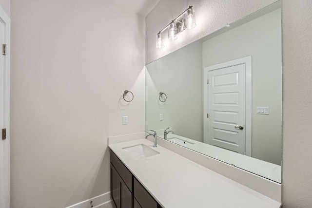 bathroom with vanity and baseboards