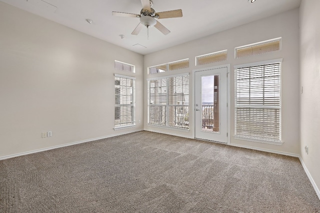 carpeted spare room with ceiling fan