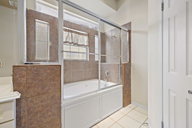 bathroom with tile patterned flooring and bath / shower combo with glass door