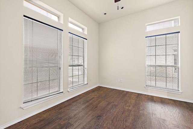 empty room featuring ceiling fan and dark hardwood / wood-style flooring