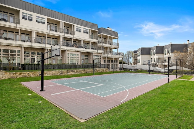 view of sport court with a yard