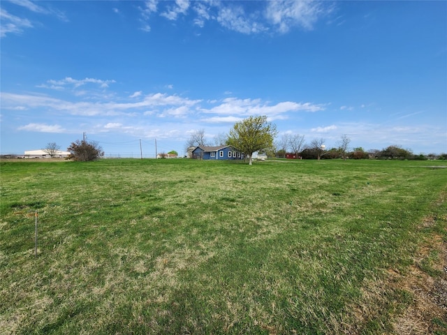 view of yard with a rural view