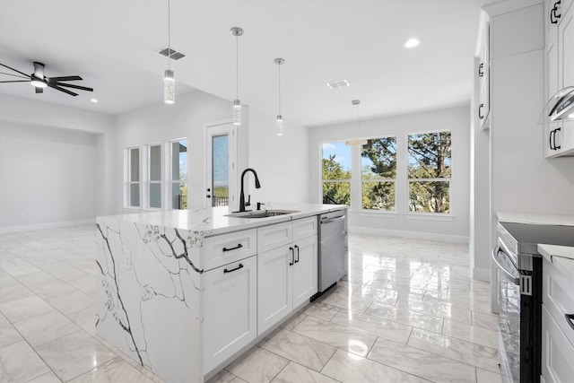 kitchen featuring decorative light fixtures, white cabinets, a center island with sink, electric stove, and sink