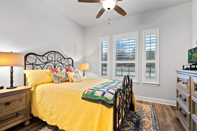 bedroom with dark hardwood / wood-style flooring and ceiling fan