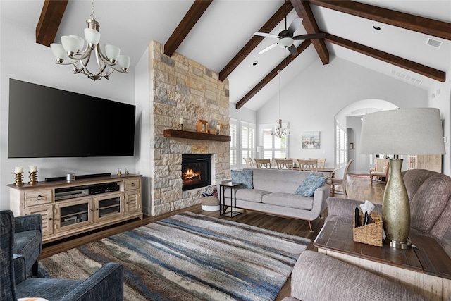 living room with ceiling fan, high vaulted ceiling, dark hardwood / wood-style flooring, beam ceiling, and a stone fireplace