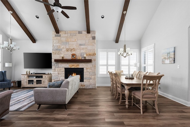 dining area with ceiling fan with notable chandelier, a fireplace, beamed ceiling, and dark hardwood / wood-style floors