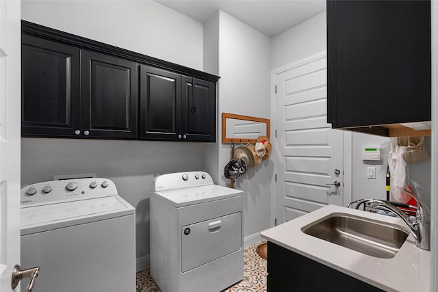 washroom with washing machine and dryer, cabinets, and sink