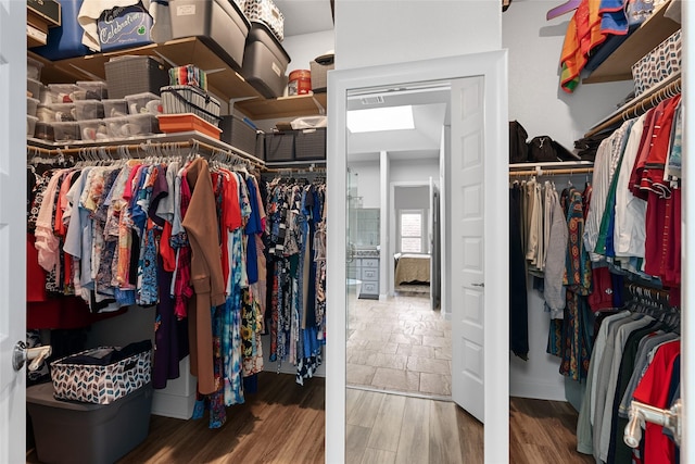 walk in closet with hardwood / wood-style flooring