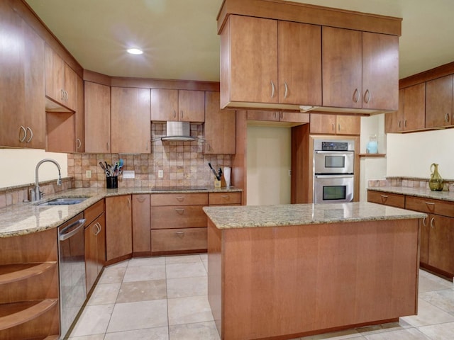 kitchen with light stone counters, appliances with stainless steel finishes, a center island, light tile floors, and sink