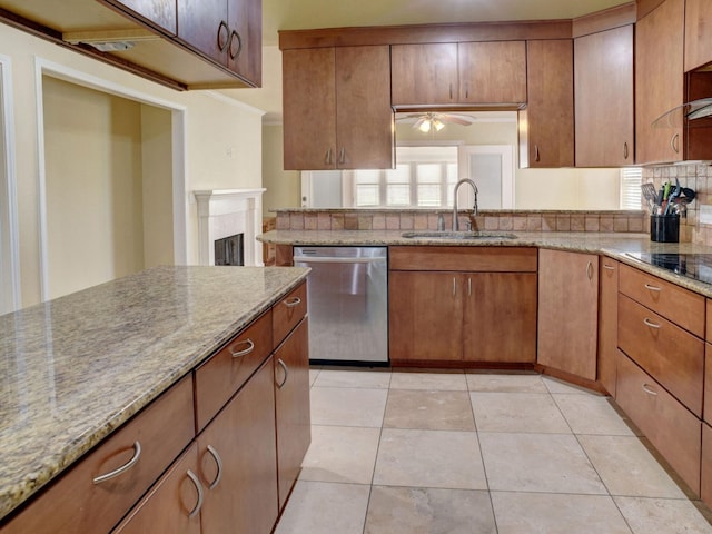 kitchen featuring ceiling fan, light tile floors, sink, stainless steel dishwasher, and light stone countertops