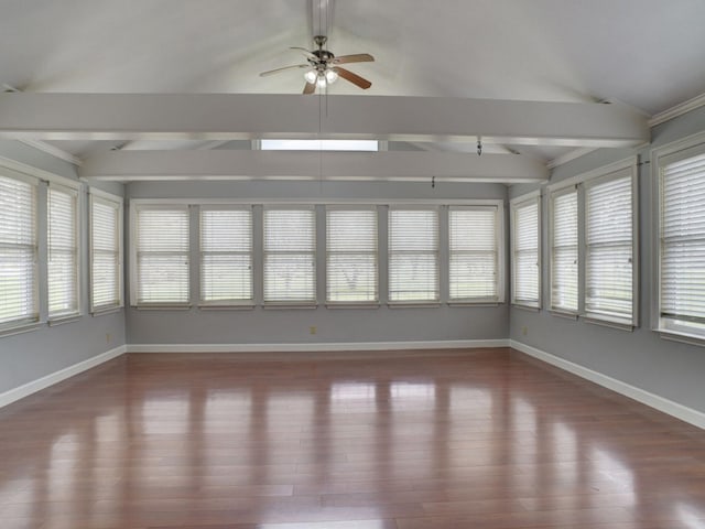 unfurnished sunroom with vaulted ceiling with beams, ceiling fan, and a wealth of natural light