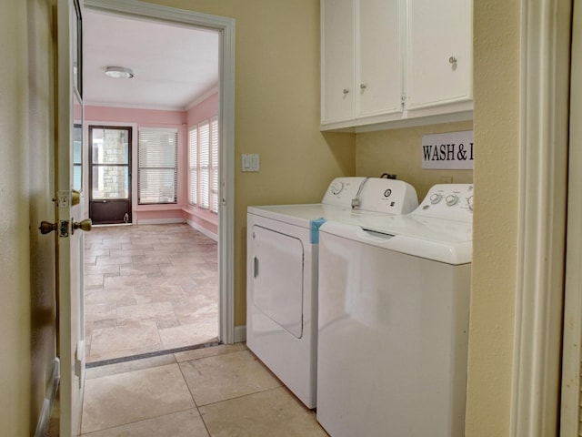 laundry area with cabinets, separate washer and dryer, and light tile floors