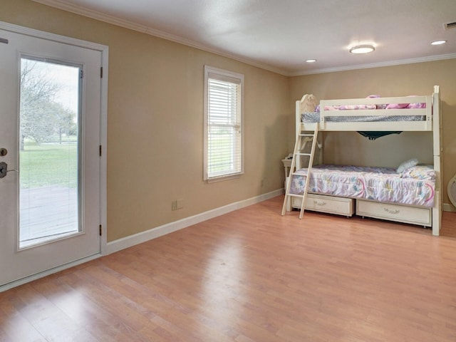 bedroom featuring ornamental molding, light hardwood / wood-style floors, and access to exterior